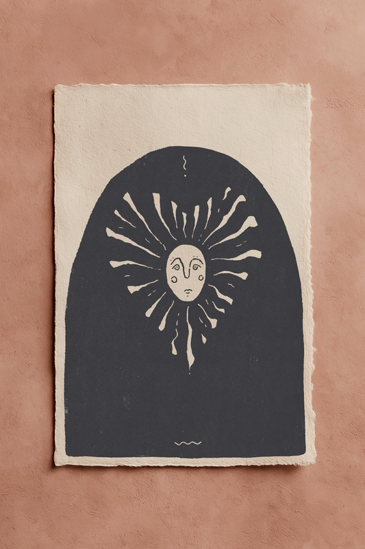Bold blackwork drawing of a sunshine in a heart shape with a fineline face with a sun design on an off-white textured background. The page is on a terracotta background.