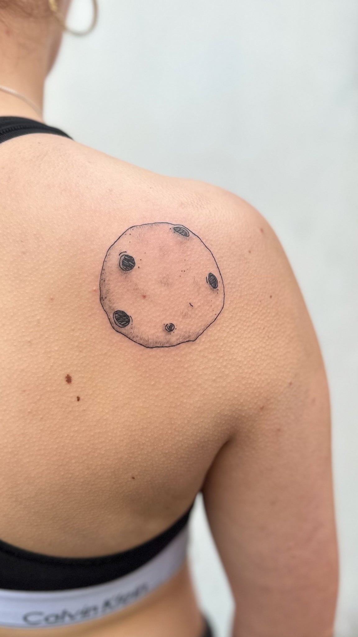 Dotwork full moon with craters on a shoulder blade, tattoo by Eli Inking, Bristol
