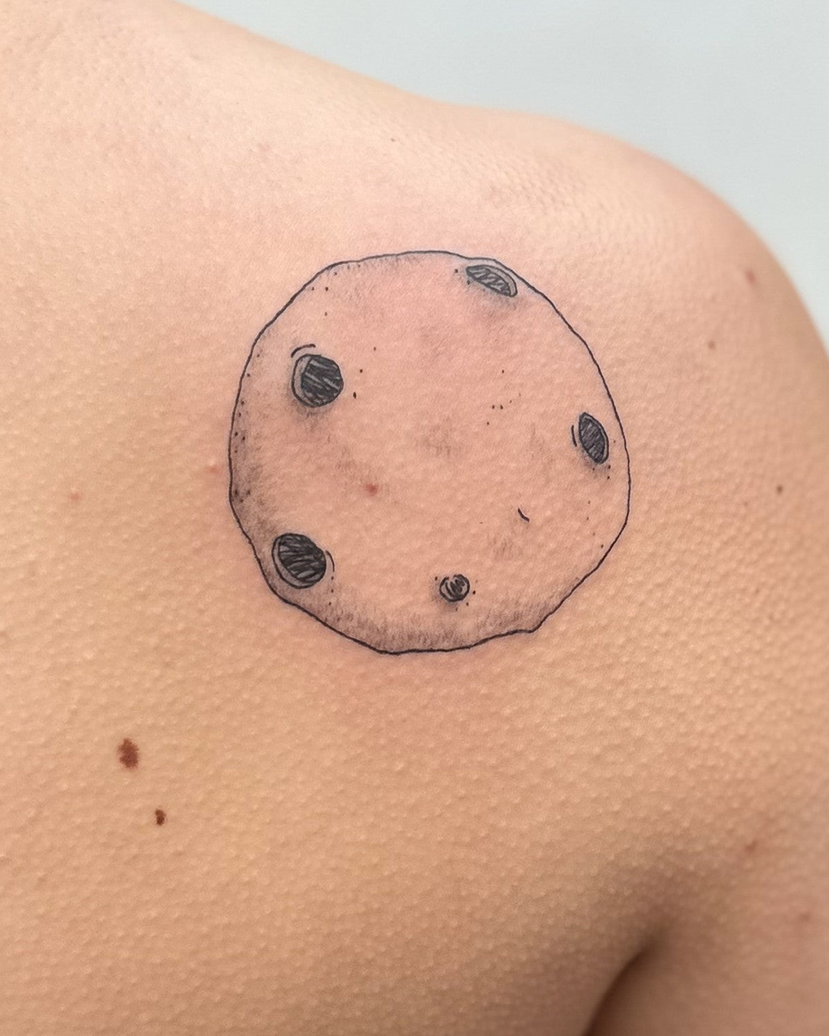 Dotwork full moon tattoo with craters, close up on a shoulder blade, by Eli Inking, Bristol
