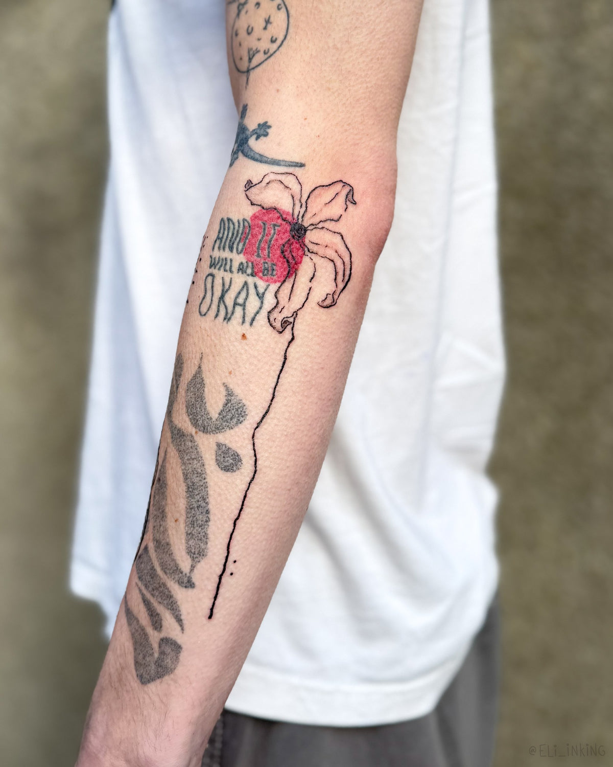 Blastover flower tattooed over an existing arm composition in bold black line