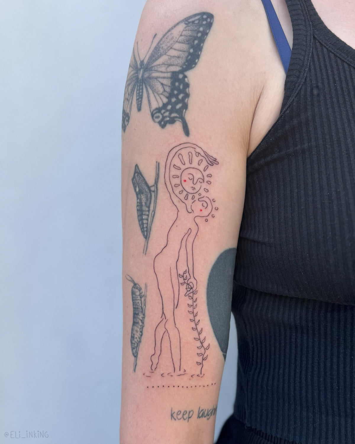 Tall single-line figure tattooed on an upper arm, fitted between existing patchwork pieces