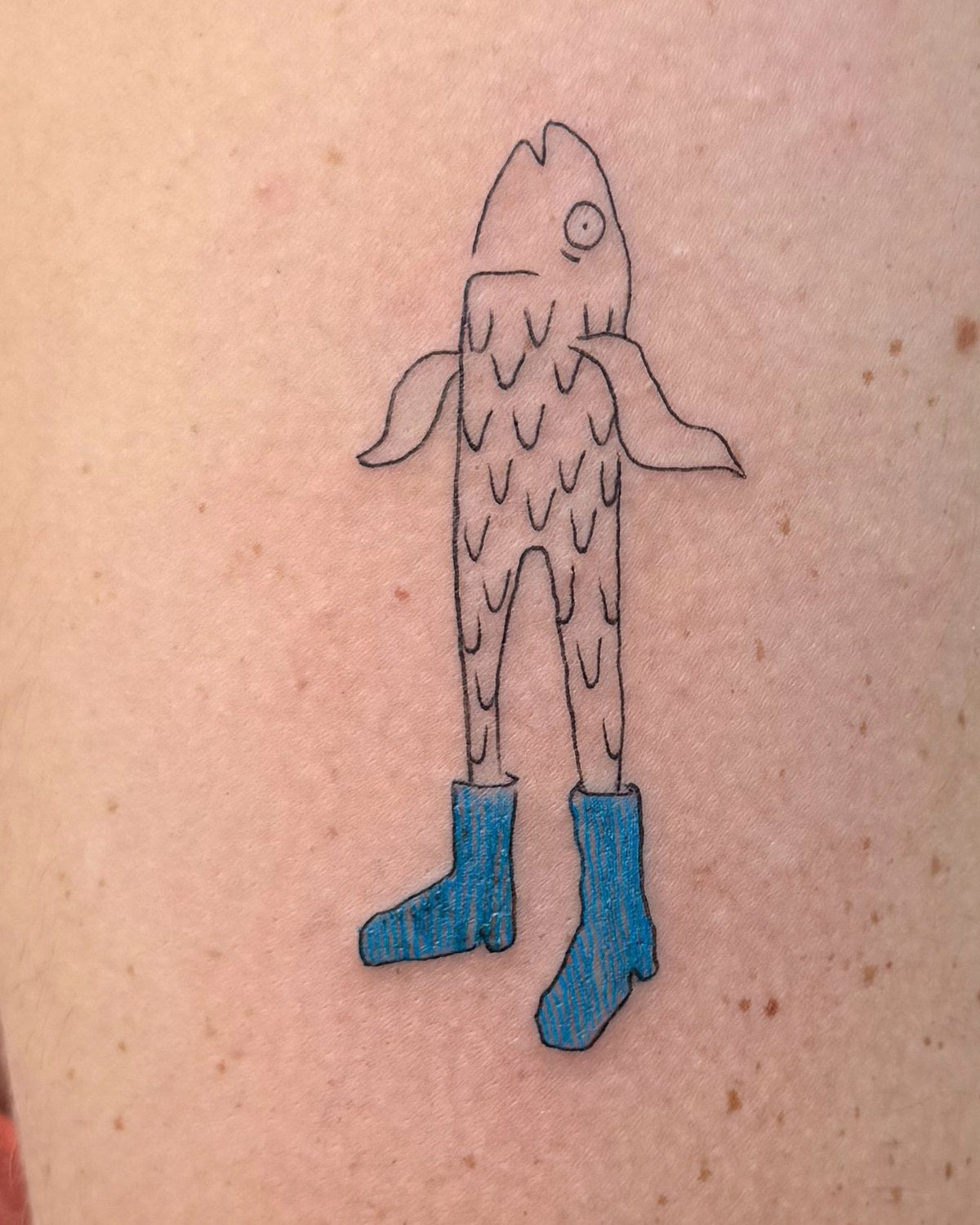 Fish in blue boots tattoo by Eli Inking
